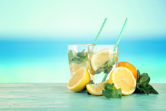 Glasses of lemonade on blurred background
