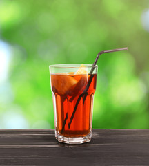 Glass of lemonade tea on blurred background