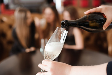 Man pours champagne in wineglasses