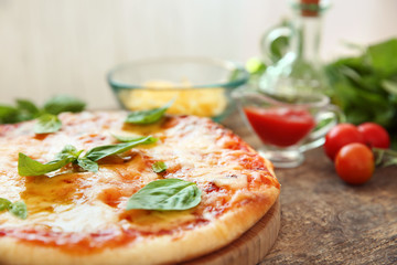 Tasty pizza on wooden table