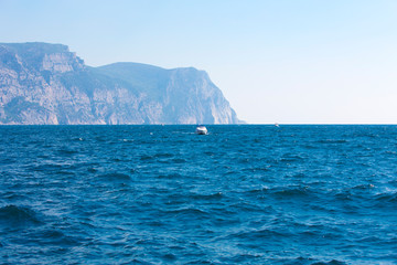 Fototapeta na wymiar The view of endless blue of the sea and fishing ship
