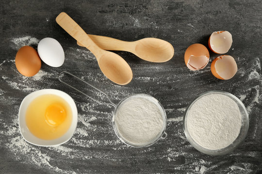 Set of products for making dough on grey textured background