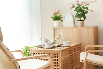 Beautiful modern veranda with cozy armchairs and coffee table
