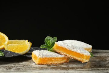 Fototapeta na wymiar Delicious lemon pie bars on dark background