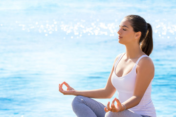 Fototapeta premium Girl doing meditation exercise at sea front.