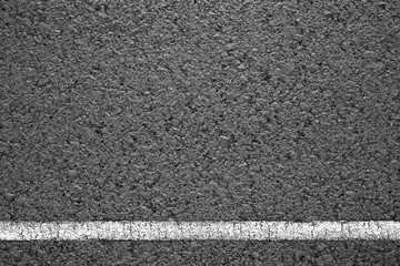 Fototapeta premium Asphalt background texture with some fine grain with road line on white