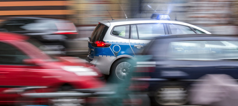 german police car speeding in city traffic