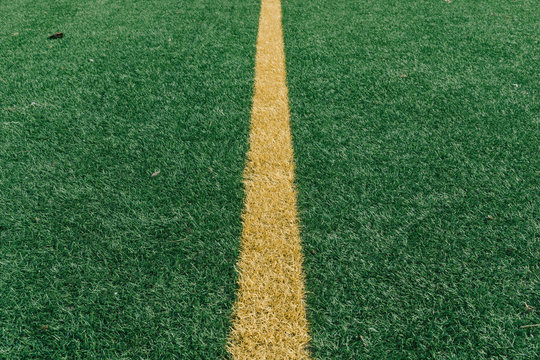Yellow middle line on grass sports field