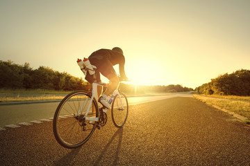 Fototapeta na wymiar Man taking a bike ride in sunset
