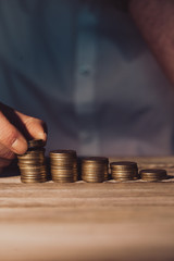 Stacking money coins, business casual man on table