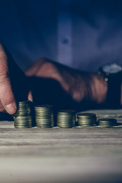 Stacking money coins, business casual man on table