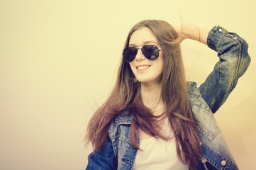 Young attractive caucasian stylish woman wearing blue jeans jacket, studio background. Closeup portrait, trendy lifestyle