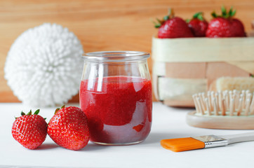 Homemade strawberry face mask in a glass jar. Diy cosmetics.