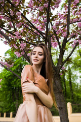Naklejka premium Happy travel woman look map and smile with sakura cherry blossoms tree on vacation while spring,