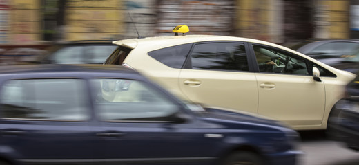 Fototapeta na wymiar german taxi cab speeding in the city