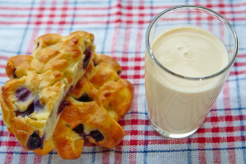 Milk in a glass and baking with berries, tasty breakfast, view from above