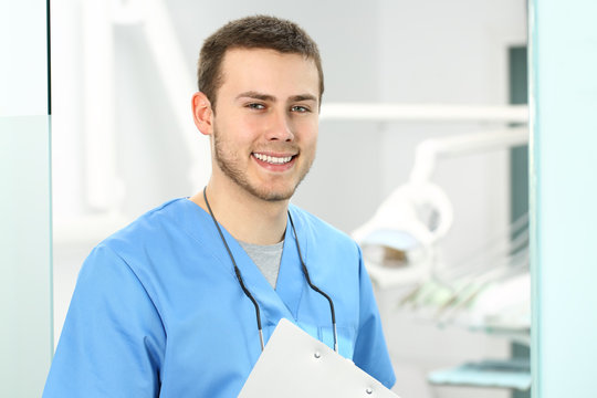 Doctor male posing in an dentist office