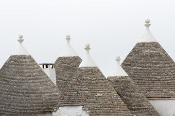 Alberobello, Italy - May 25, 2017: Trulli stone roof of the Apulian village, with the sky background