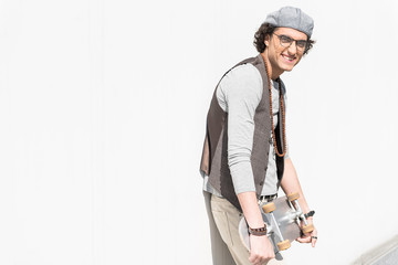 Positive stylish teenager standing outdoors