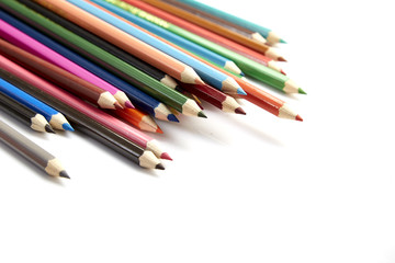 Many different colored pencils on white background