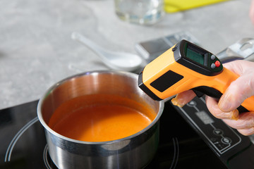 measuring the temperature of cream soup