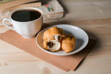 coffee Cup and croissant on wooden background