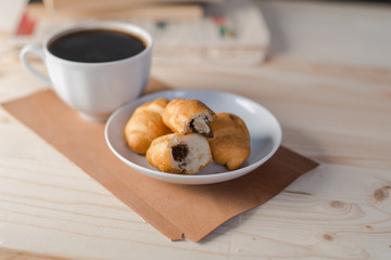 coffee Cup and croissant on wooden background