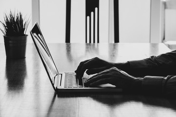 Man hands typing on a laptop in a workplace. Business black and white. - 158726950