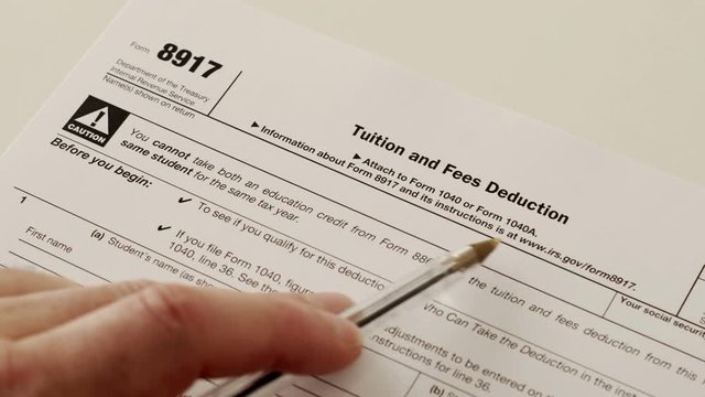 An anonymous person reading the Internal Revenue Service form 8917 which is used for and income tax reduction for tuition and education fees that have been paid by the claimant.