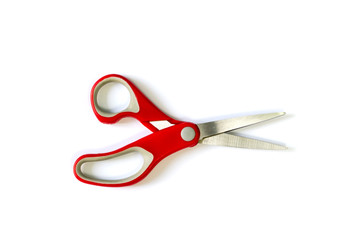 Red scissors on white background