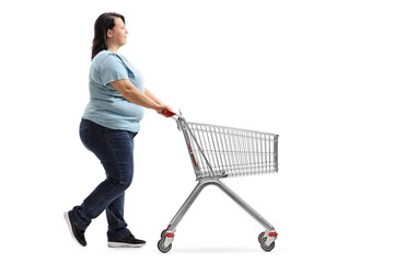 Woman pushing an empty shopping cart