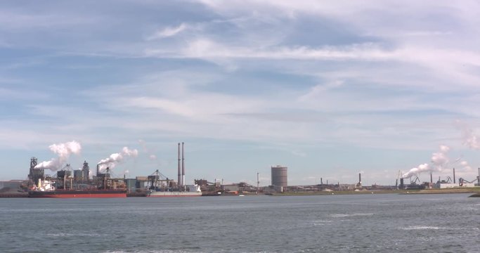 IJMUIDEN, THE NETHERLANDS - MAY 2017:  skyline Royal Dutch Blast Furnaces and Steelworks at the north bank of the North Sea Canal + pan. The IJmuiden steelworks now is a part of Tata Steel Europe.