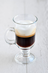 Coffee in a glass on a wooden table