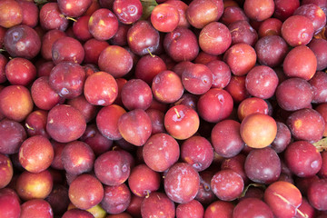 Fresh ripe red plums as a background
