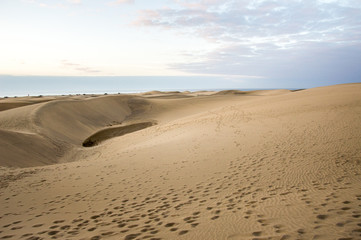 Fototapeta na wymiar Footprints on sand dunes