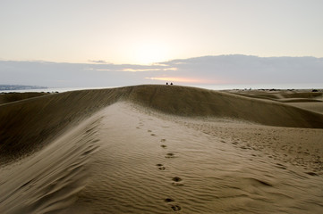 Fototapeta na wymiar Footprints on sand dunes