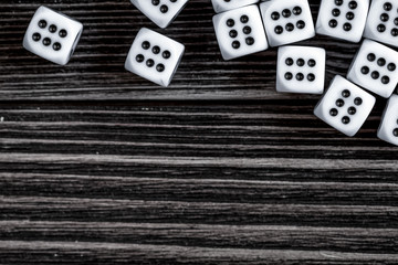 risk concept playing dice at dark wooden background top view