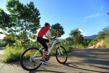 Fototapeta na wymiar riding mountain bike on sunrise forest trail