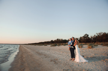 happy family watching the sunset on the beach
