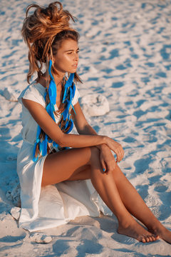attractive bohemian style woman on beach