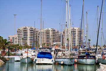 Fototapeta na wymiar Boat and yacht on a bright sunny day in the seaport of Marina de las Dunas, Guardamar del Segura, Alicante, Spain.