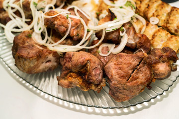 Prepared shashlik on dish with onion rings