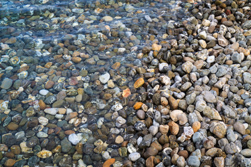 Background of rounded pebbles at sea coast.