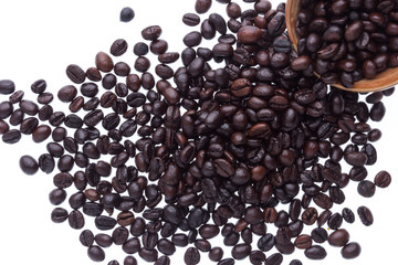 Spilled coffee beans from the white ceramic cup