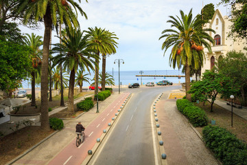 Fototapeta na wymiar Bikers on bicycle path in Kos town in Greece.