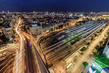 Aerial panorama of the Bucharest central train station - Bucharest Nord. Traffic and buildings after the sunset.	