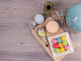 Sweet colorful macaroons on a wood background