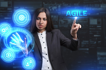 The concept of business, technology, the Internet and the network. A young entrepreneur working on a virtual screen of the future and sees the inscription: Agile