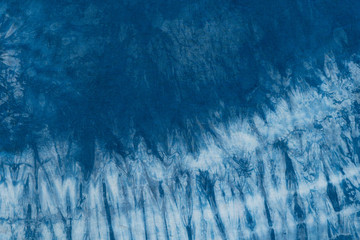 Pattern of blue dye on cotton cloth, Dyed indigo fabric background and textured