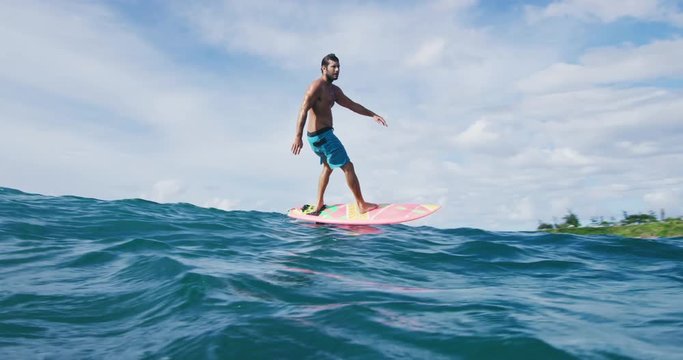 Surfer on hydrofoil surfboard riding blue ocean wave. Futuristic surfing on hoverboard